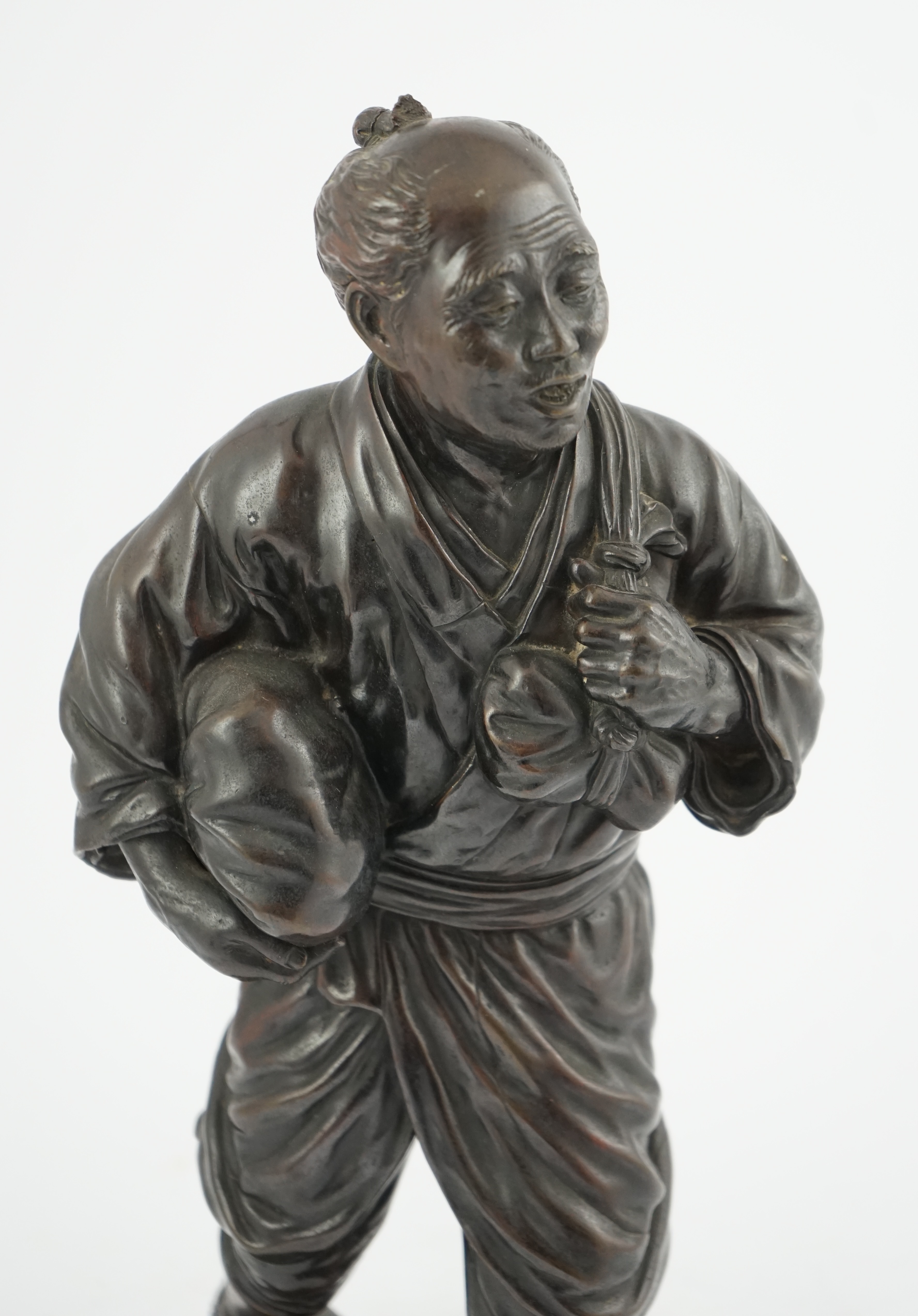 A Japanese bronze figure of a man, 19th century